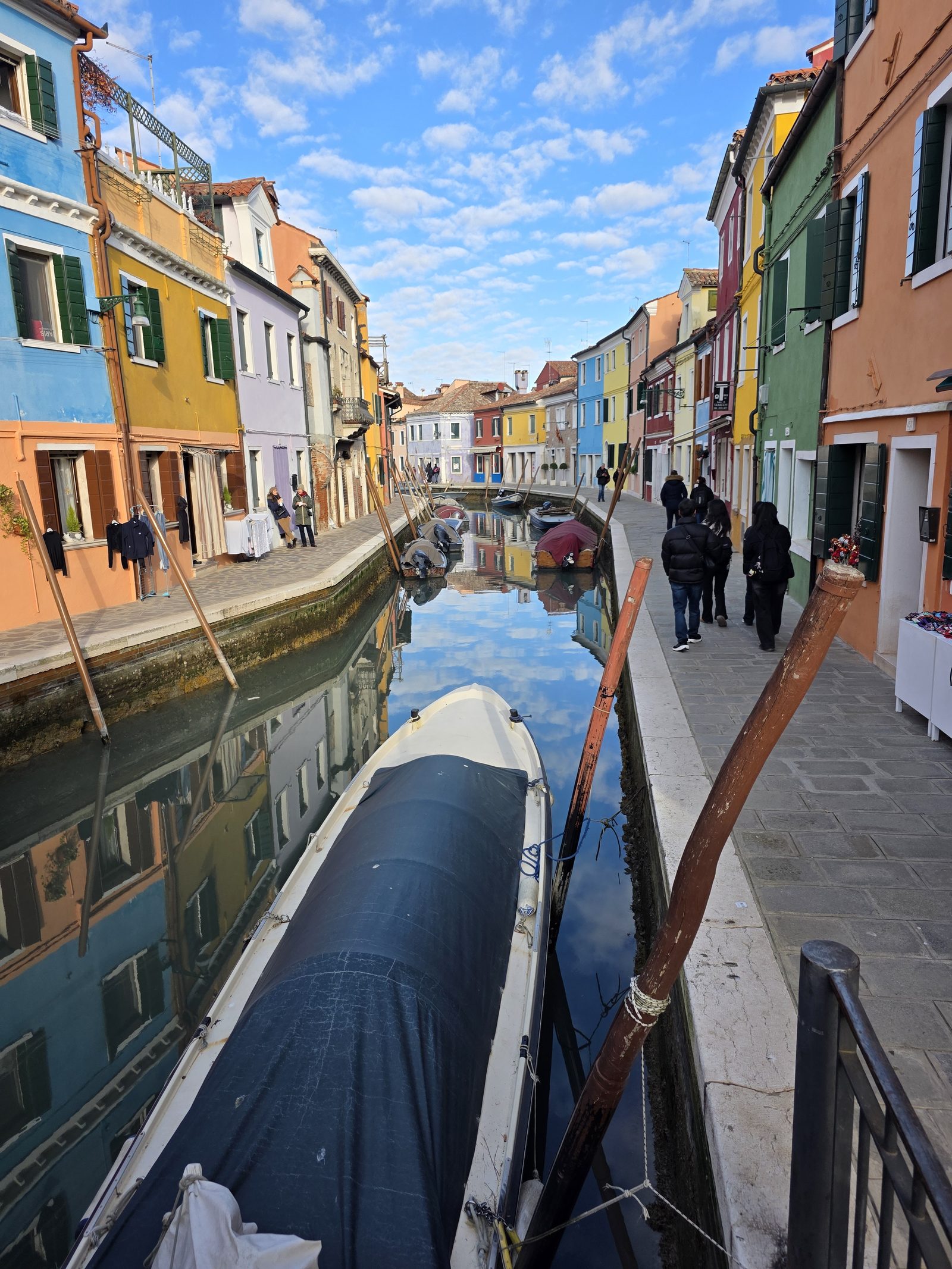 Boot vor bunten Fassaden am Kanal von Burano